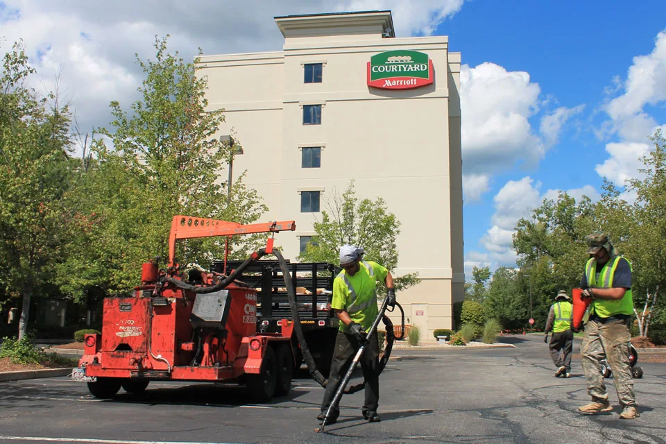 U.S. Pavement employee filling in cracks
