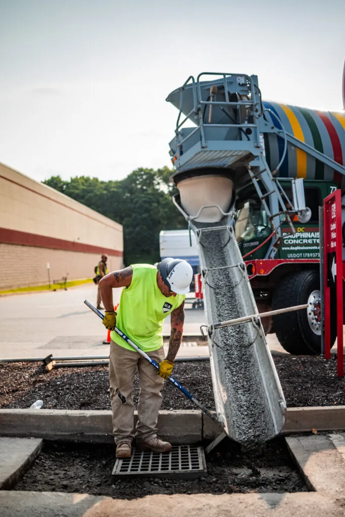 person repairing a drainage grate