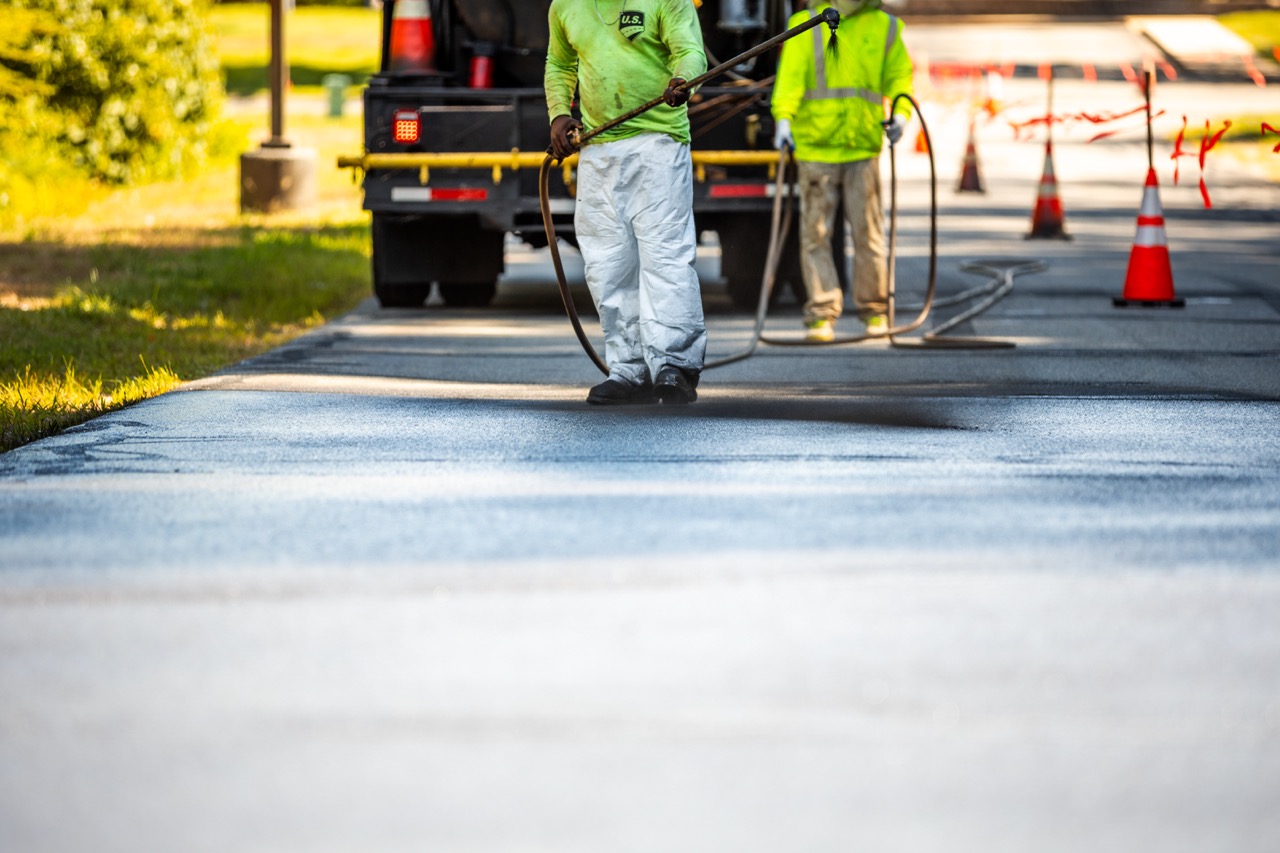 us pavement employees sealcoating a street