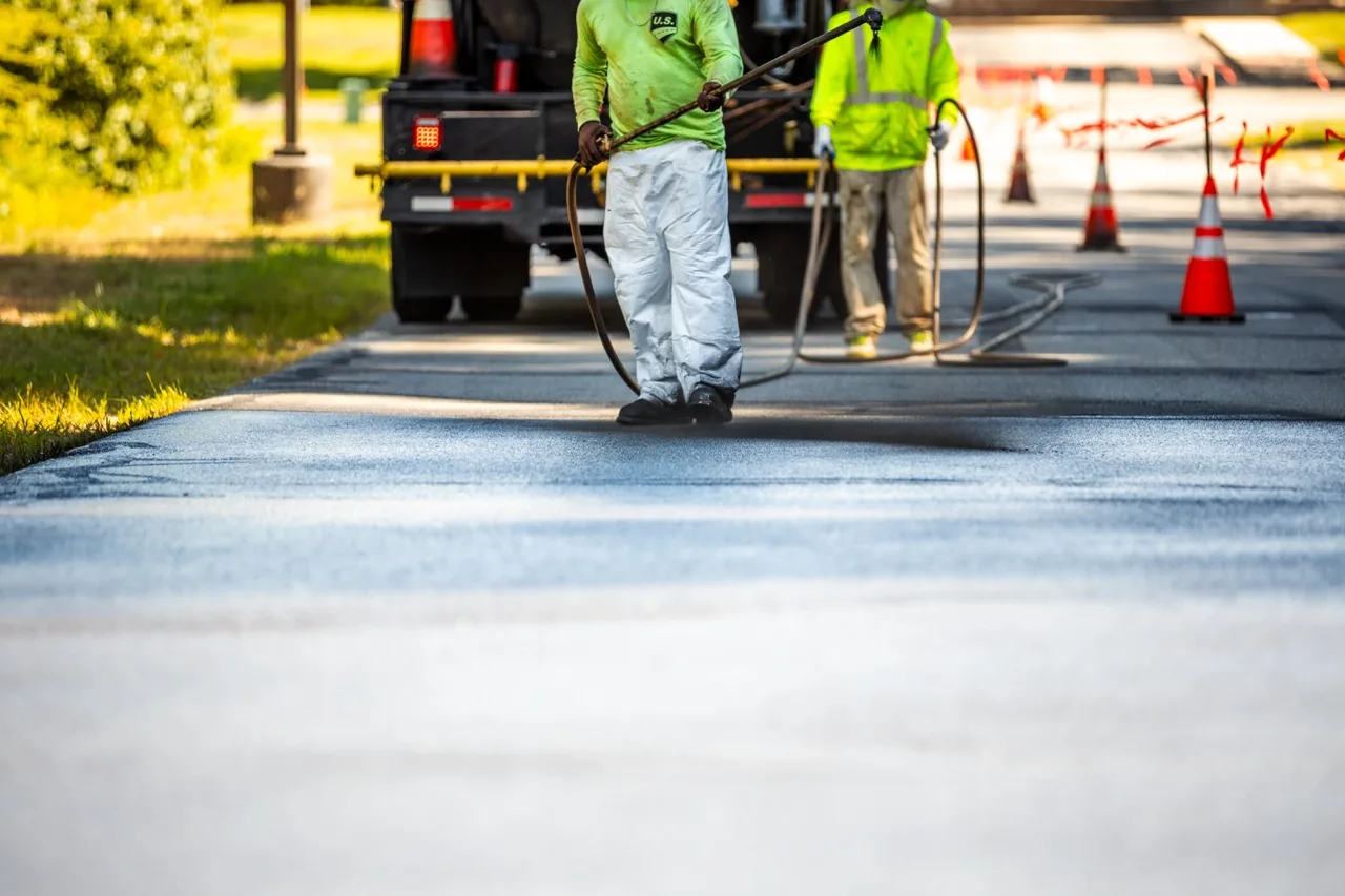 us pavement employees sealcoating a street