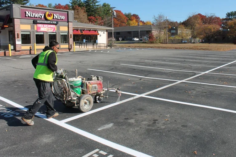 u.s. pavement employee operating a line striping machine