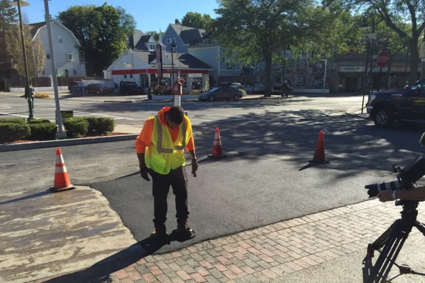 u.s. pavement employee patching asphalt